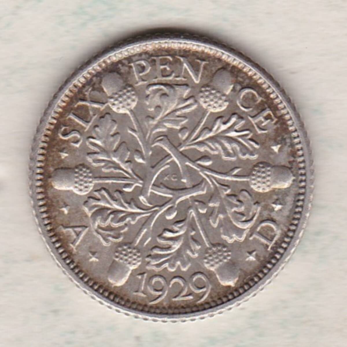 1929 Silver Sixpence coin featuring King George V on the Obverse. The Reverse features three oak sprigs with date and denomination.