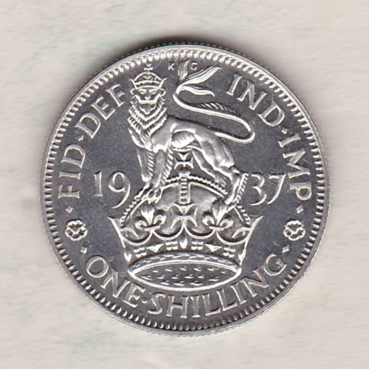1937 Proof English Silver Shilling coin featuring King George VI on the Obverse. The Reverse features a crowned lion with date and denomination.