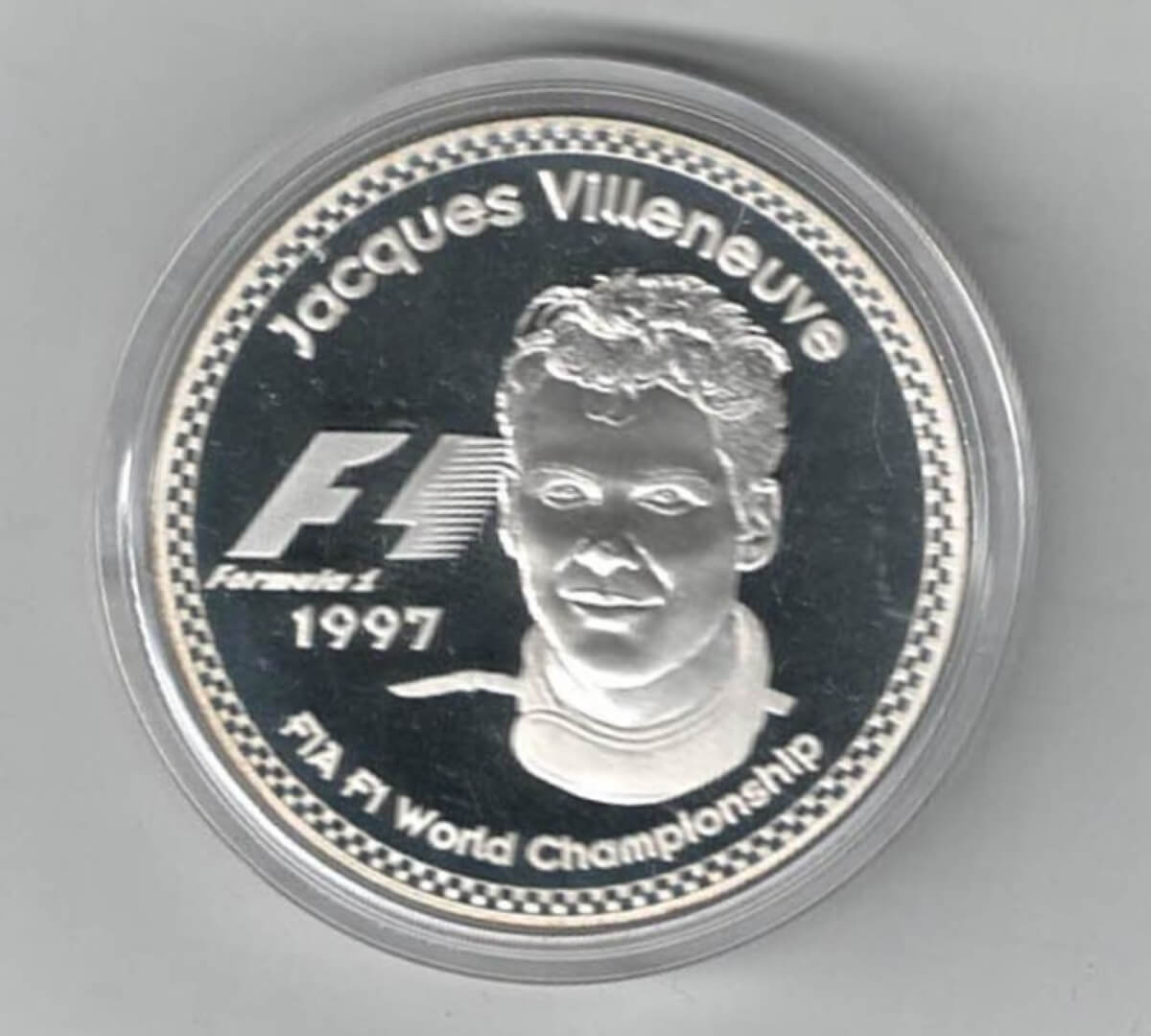 1997 Jacques Villeneuve Silver Proof Twenty Five Euro Coin. This coin features Ayrton Senna with the championship winning dates.