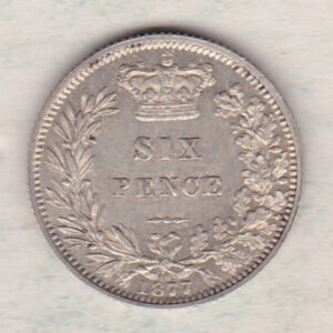 1877 silver sixpence coin featuring young head Queen Victoria on the Obverse. The crowned denomination within a wreath and date below on the Reverse.