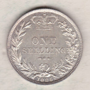 1885 silver shilling coin featuring Queen Victoria young head on the Obverse. The Reverse has a crown, laurel and oak leaves within an open wreath.