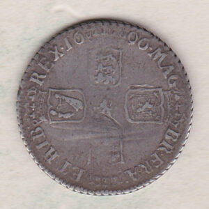 1696 B silver shilling coin featuring the laureate or draped bust of William III on the Obverse. The crowned cruciform shields on the Reverse.