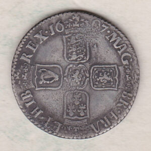 1697 silver shilling coin featuring the laureate or draped bust of William III on the Obverse. The crowned cruciform shields on the Reverse.