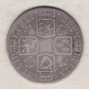 1717 silver shilling coin featuring a laureate and draped bust of George I. The crowned cruciform shields with central Garter star on the Reverse.