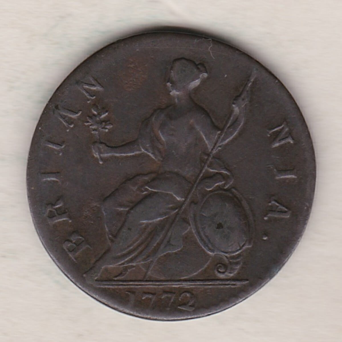 1772 copper halfpenny coin featuring King George III on the Obverse. Britannia seated facing left holding a trident on the Reverse.