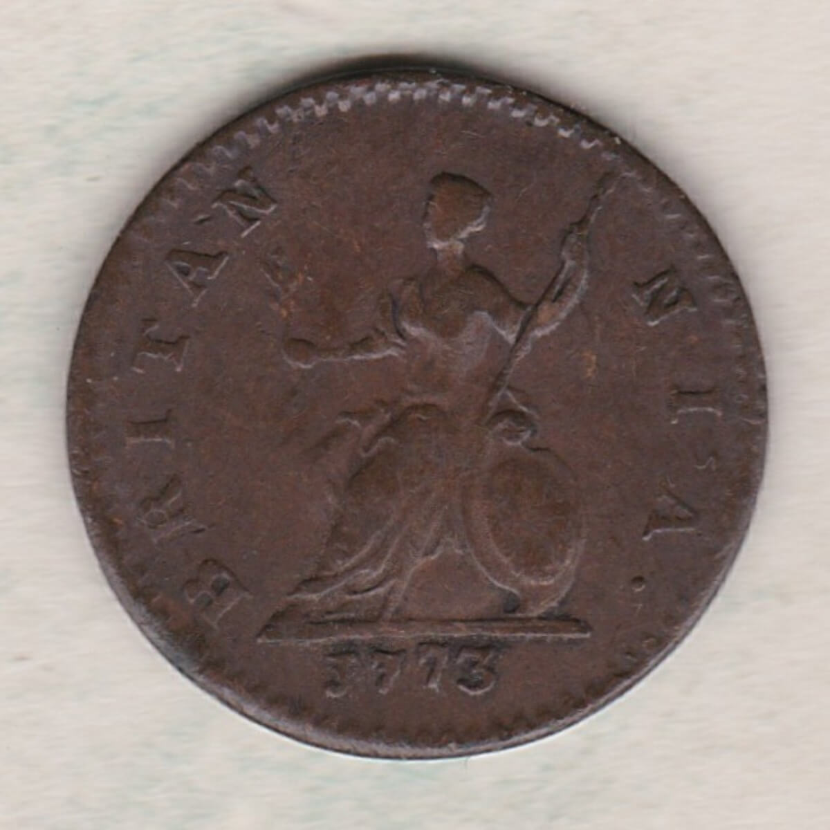 1773 copper farthing coin featuring the portrait of King George III on the Obverse. Britannia seated facing left on the Reverse.