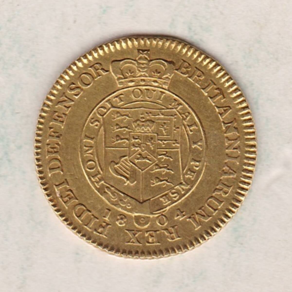 1804 Gold Half Guinea Coin featuring the laureate head portrait of King George III on the obverse. The reverse features the crowned shield of arms.
