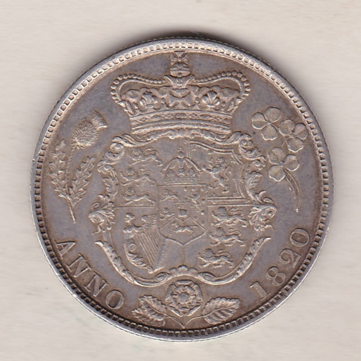 1820 Silver Halfcrown coin with King George IV on the Obverse. The reverse features the first crowned and Mantled shield of arms.