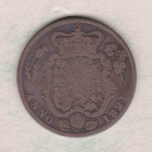 1821 silver shilling coin featuring King George IV on the Obverse. The Reverse has the crowned and garnished shield of arms with national flower emblems.