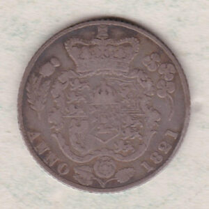1821 silver sixpence coin featuring King George IV on the Obverse. The reverse features an ornate garnished crowned quartered shield of arms.