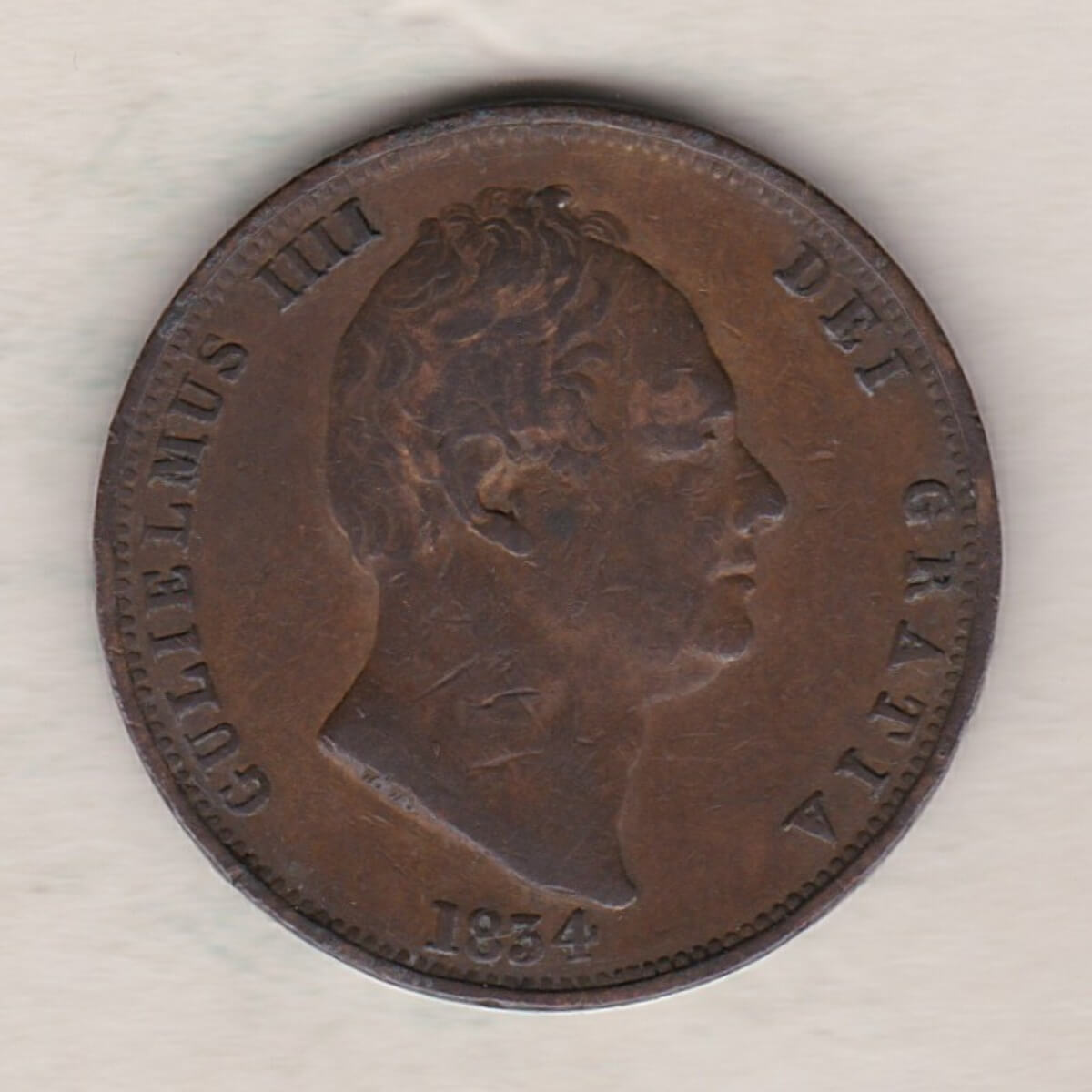 1834 copper halfpenny coin featuring King William IV on the Obverse. Britannia seated facing right holding a trident on the Reverse.