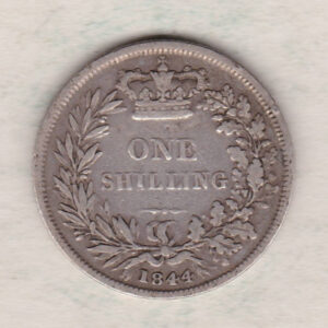 1844 silver shilling coin featuring Queen Victoria young head on the Obverse. The Reverse has a crown, laurel and oak leaves within an open wreath.
