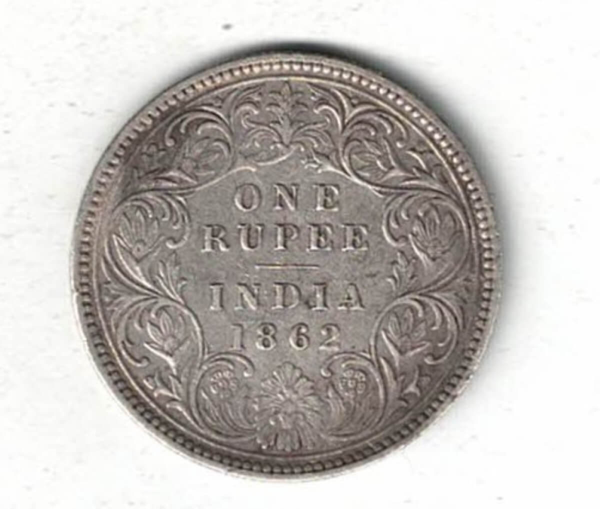 1862 India Silver One Rupee Coin. The obverse side of this coin features the crowned portrait of Queen Victoria facing left.