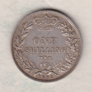 1885 silver shilling coin featuring Queen Victoria young head on the Obverse. The Reverse has a crown, laurel and oak leaves within an open wreath.