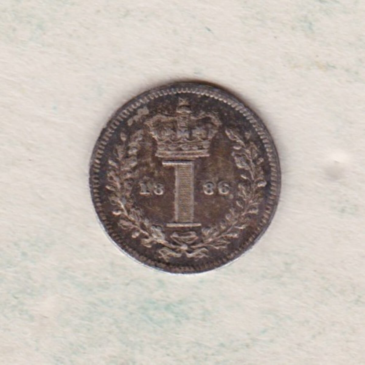 1886 Silver Maundy Penny coin featuring Queen Victoria on the obverse. A central crowned denomination above the date on the reverse.
