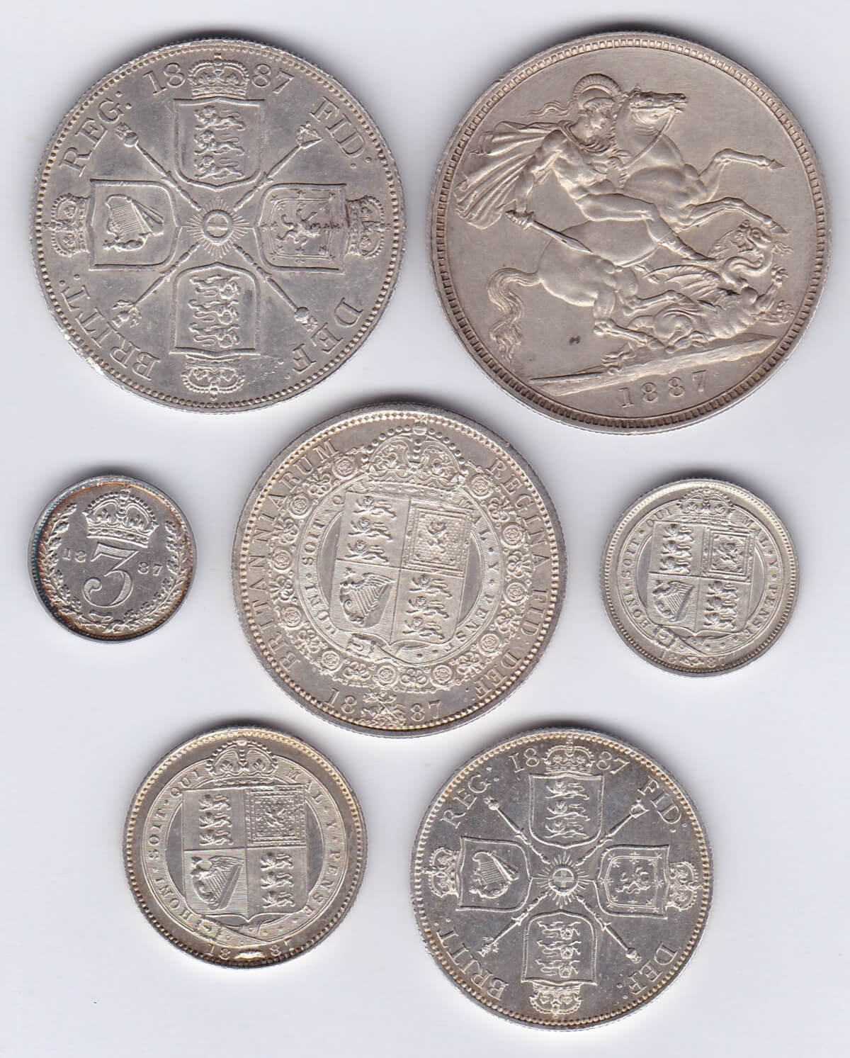 1887 Seven Coin Silver Set. This seven coin set includes the halfcrown down to threepence. Each coin features the Jubilee Head design on the obverse.