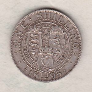1895 Silver Shilling coin featuring Queen Victoria on the Obverse. The Reverse features the crowned shields of arms with national flower emblems between.