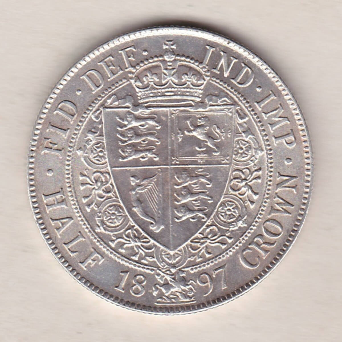 1897 Silver Halfcrown coin featuring the old head of Queen Victoria on the Obverse. The shield of royal arms completes the Reverse design.