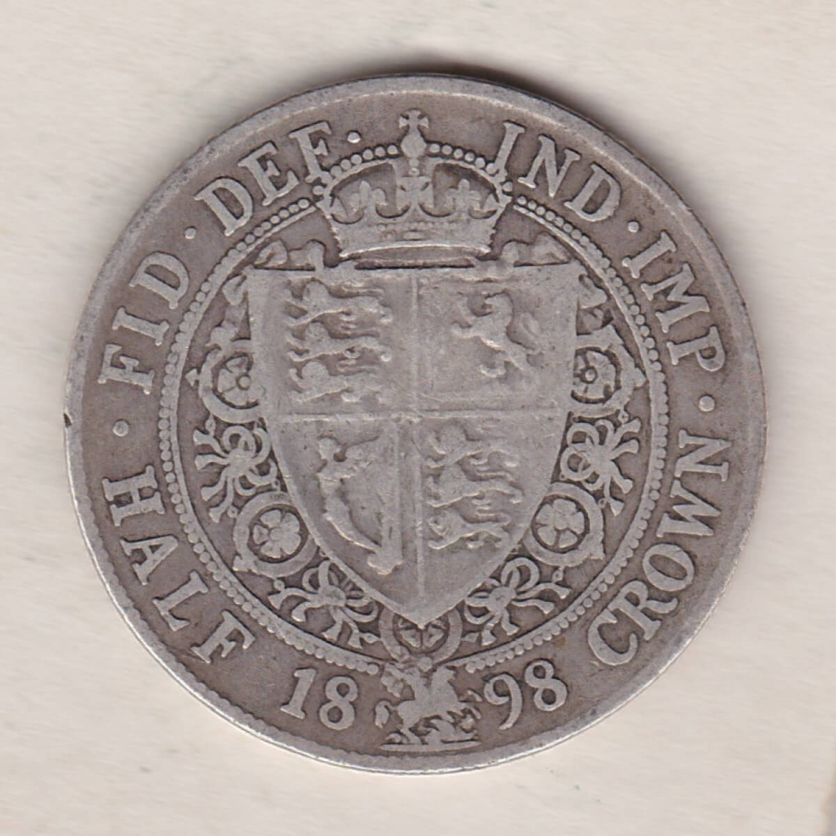 1898 Silver Halfcrown coin featuring the old head of Queen Victoria on the Obverse. The shield of royal arms completes the Reverse design.