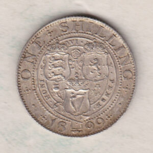 1899 Silver Shilling coin featuring Queen Victoria on the Obverse. The Reverse features the crowned shields of arms with national flower emblems between.