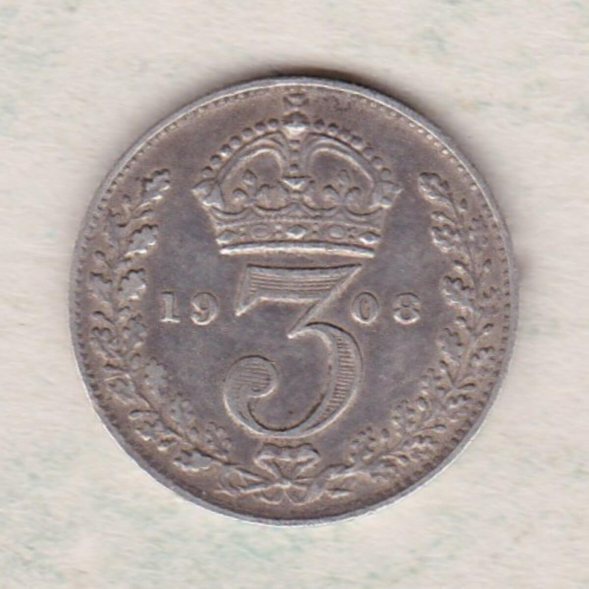 1908 Silver Threepence coin featuring the portrait of King Edward VII on the Obverse. The Reverse features a crowned denomination dividing the date.