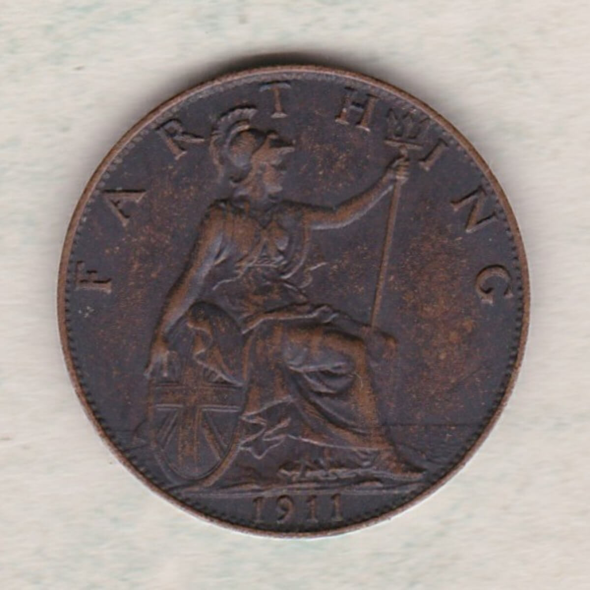 1911 bronze farthing coin featuring King George V on the obverse. The reverse features Britannia with the denomination above and date below.