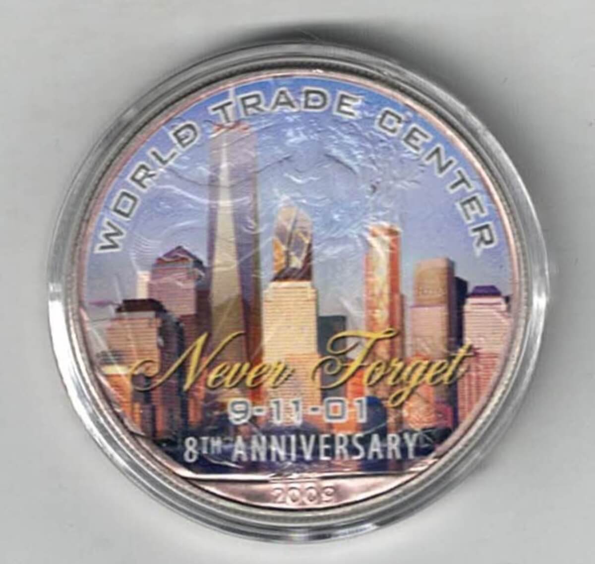 Boxed 2009 Silver USA One Ounce Eagle Colourised World Trade Centre. An eagle is on the reverse. The coin contains one ounce of 999 fine silver.